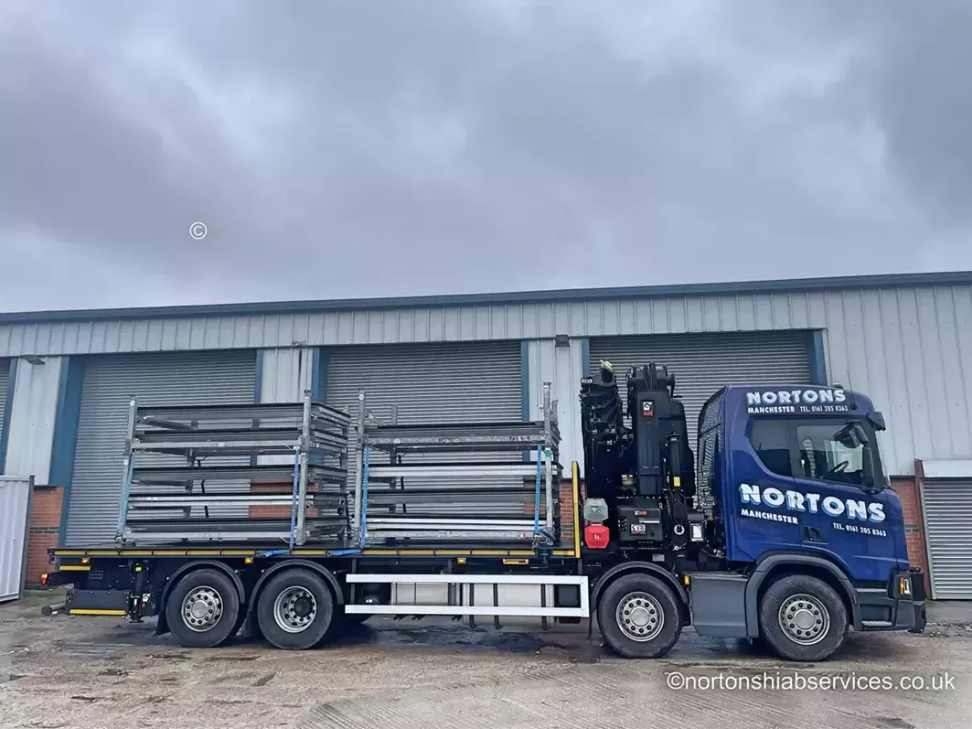 Steel stillages loaded across the deck of a Nortons hiab lorry