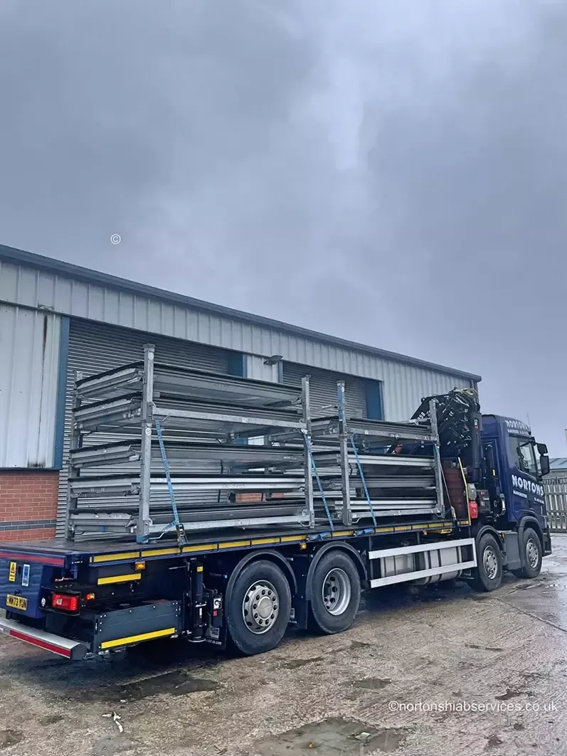 Glass stillages being delivered to a construction site by Nortons