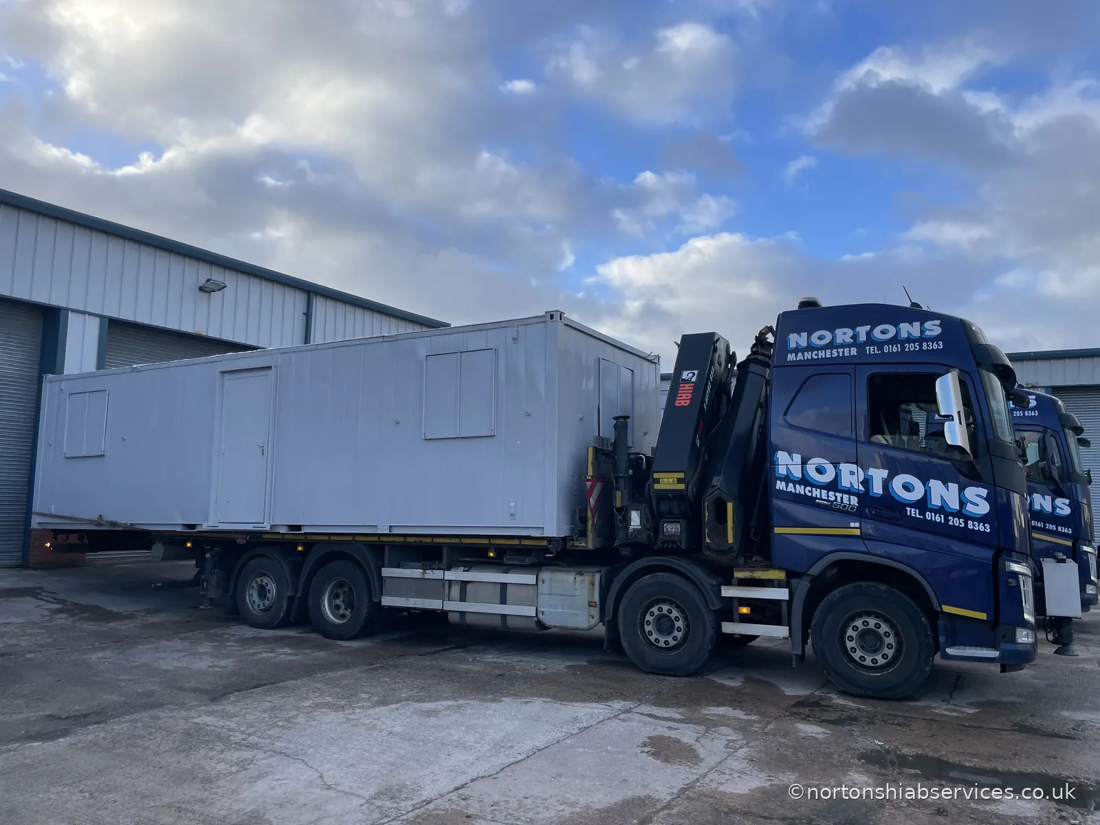 A portable cabin loaded onto a Nortons hiab lorry at the Manchester yard, ready to be called off to site