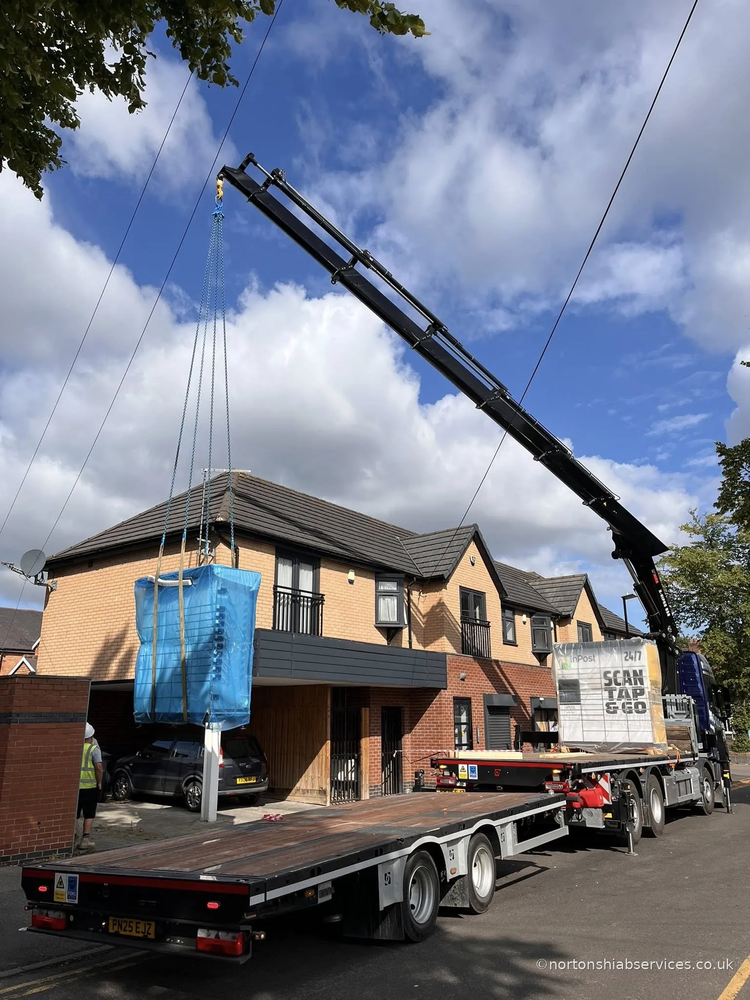 Nortons hiab lifting a bulk bag at a property in Birmingham