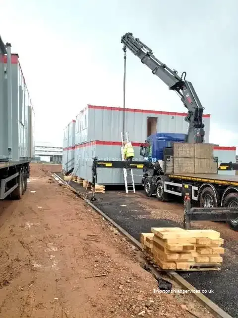 Nortons hiab arriving at a Birmingham site with cabins to place