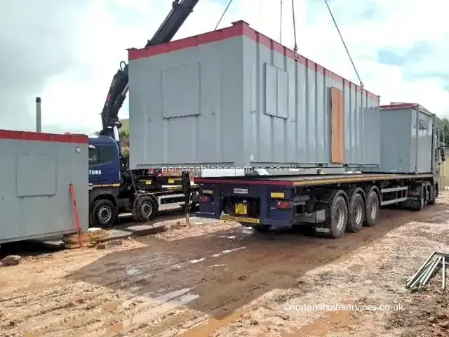 Site cabin being unloaded from a Nortons trailer in Birmingham