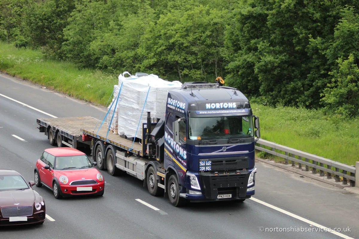 A Nortons crane lorry carrying wrapped electrical panels southbound on the M6 at Lymm in Cheshire, on the way from Ellesmere Port to London