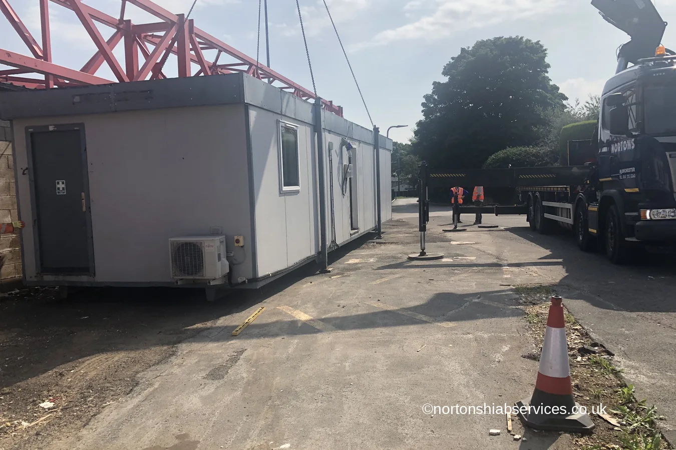A site cabin set down on hard standing at Accrington with the Nortons lorry alongside it