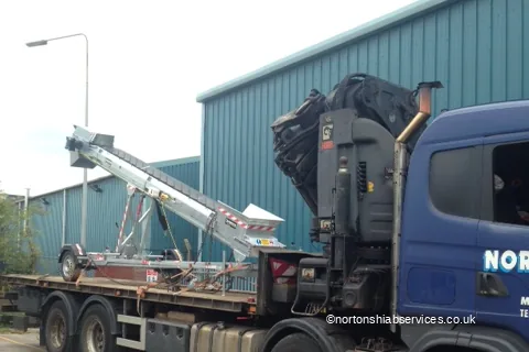 A Nortons eight-wheel rigid loaded with a sheeted cement conveyor outside an industrial unit at Burscough in Lancashire