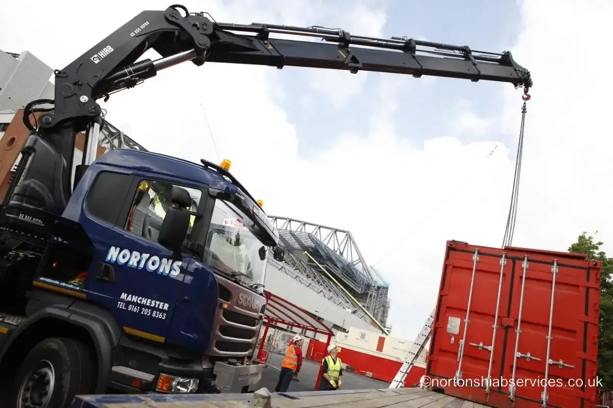 Nortons hiab with the crane boom fully extended and the hook lowered to a container at the Anfield stadium site in Liverpool