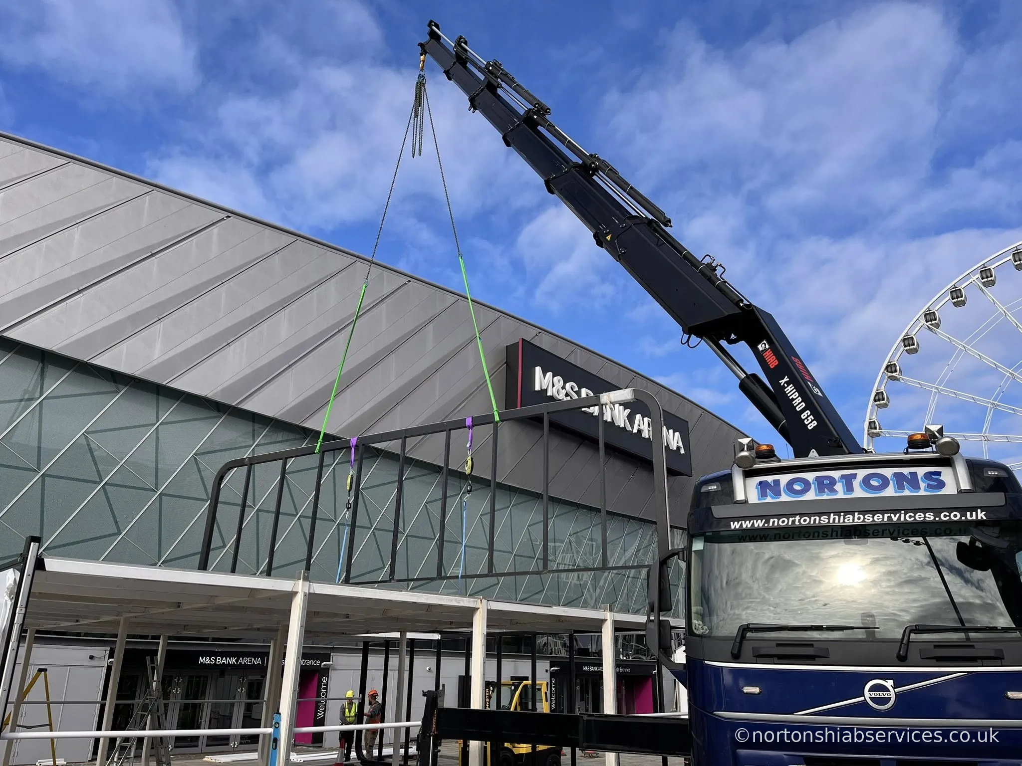 Nortons hiab lifting panels outside an arena building in Liverpool