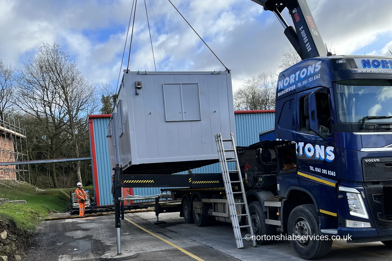 A refurbished cabin swung in over the stabiliser legs of a Nortons crane lorry at Romiley