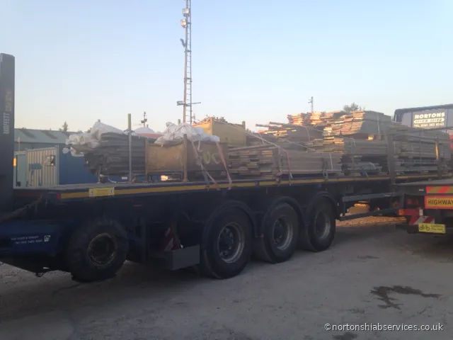 A Nortons lorry loaded with scaffolding and timber, craned off on a delivery into Warrington