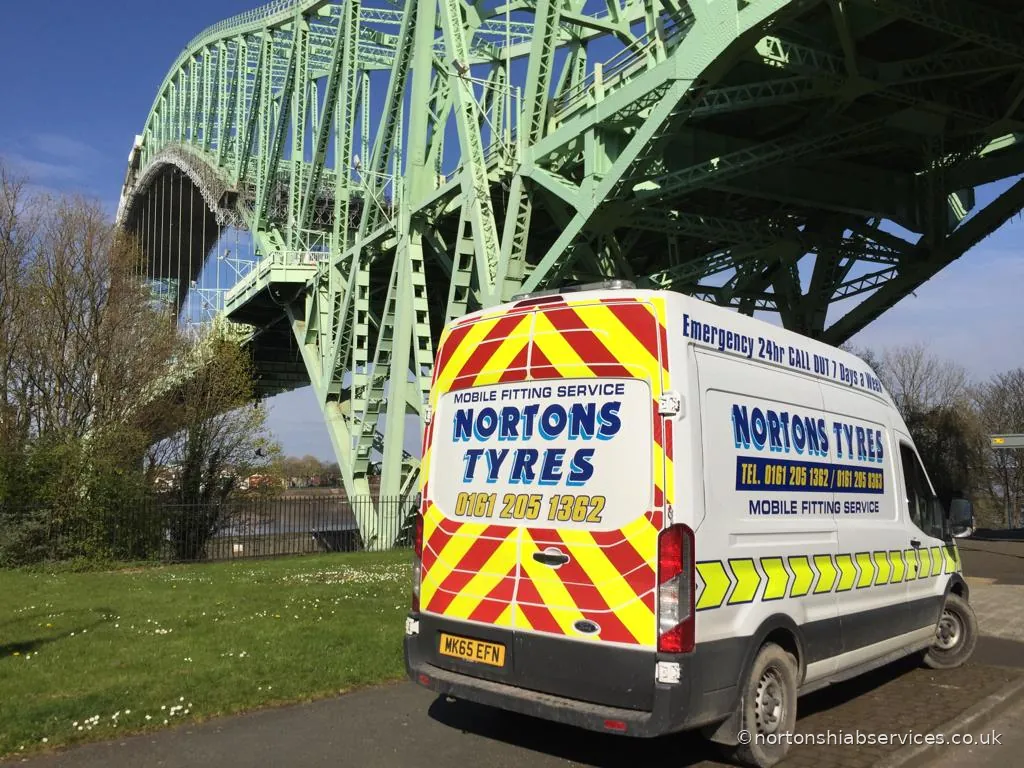 A Nortons Tyres mobile fitting van parked under the arch of the Runcorn bridge
