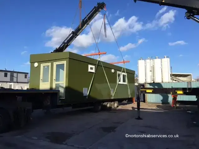 Nortons rigid hiab lifting a small site office into position