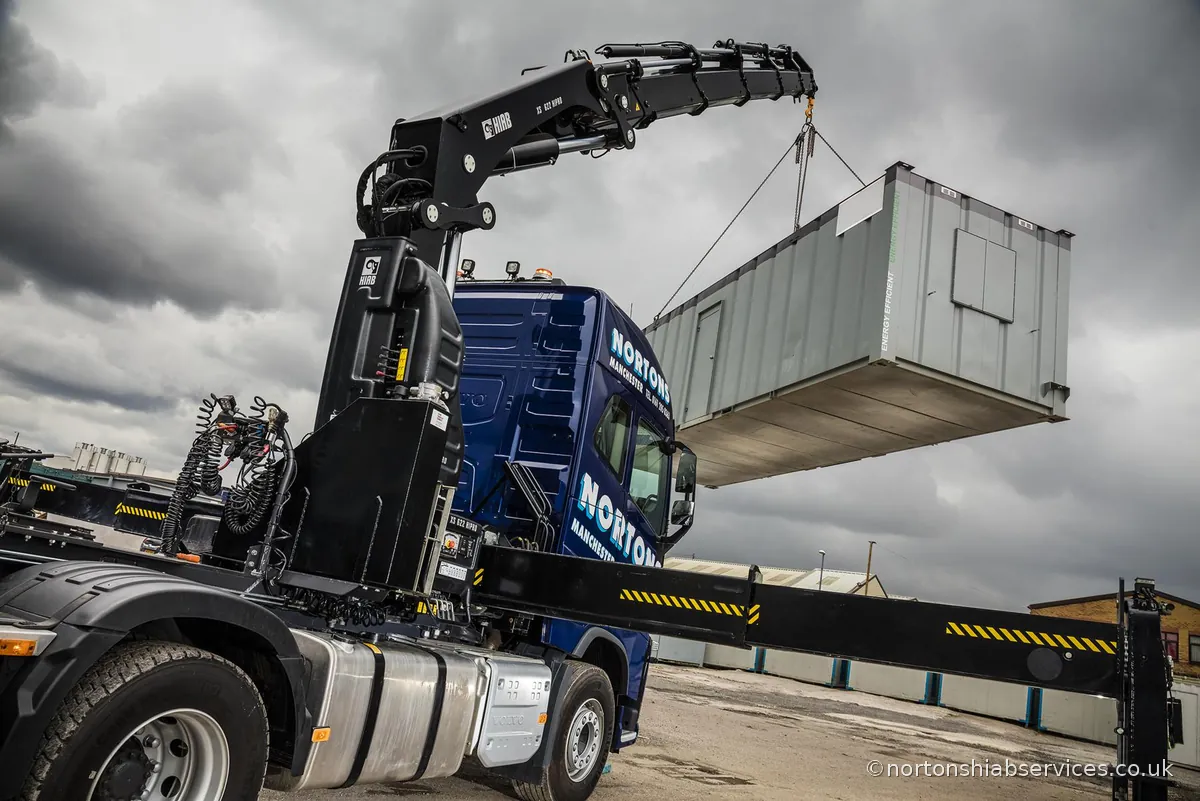 Nortons Volvo 622 hiab lifting a long modular unit level on four legs of chain