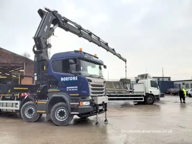 Two Nortons Scania eight-wheel rigids with 855 hiab cranes standing in the yard