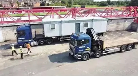Two Nortons vehicles in position with a white cabin between them