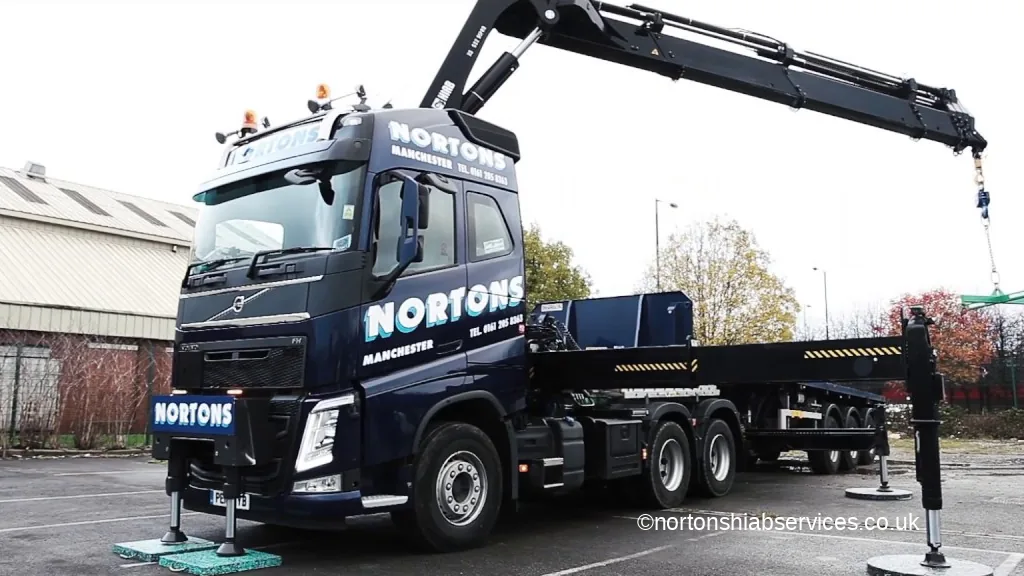 Nortons Volvo FH with the crane raised and its stabiliser legs down on the yard
