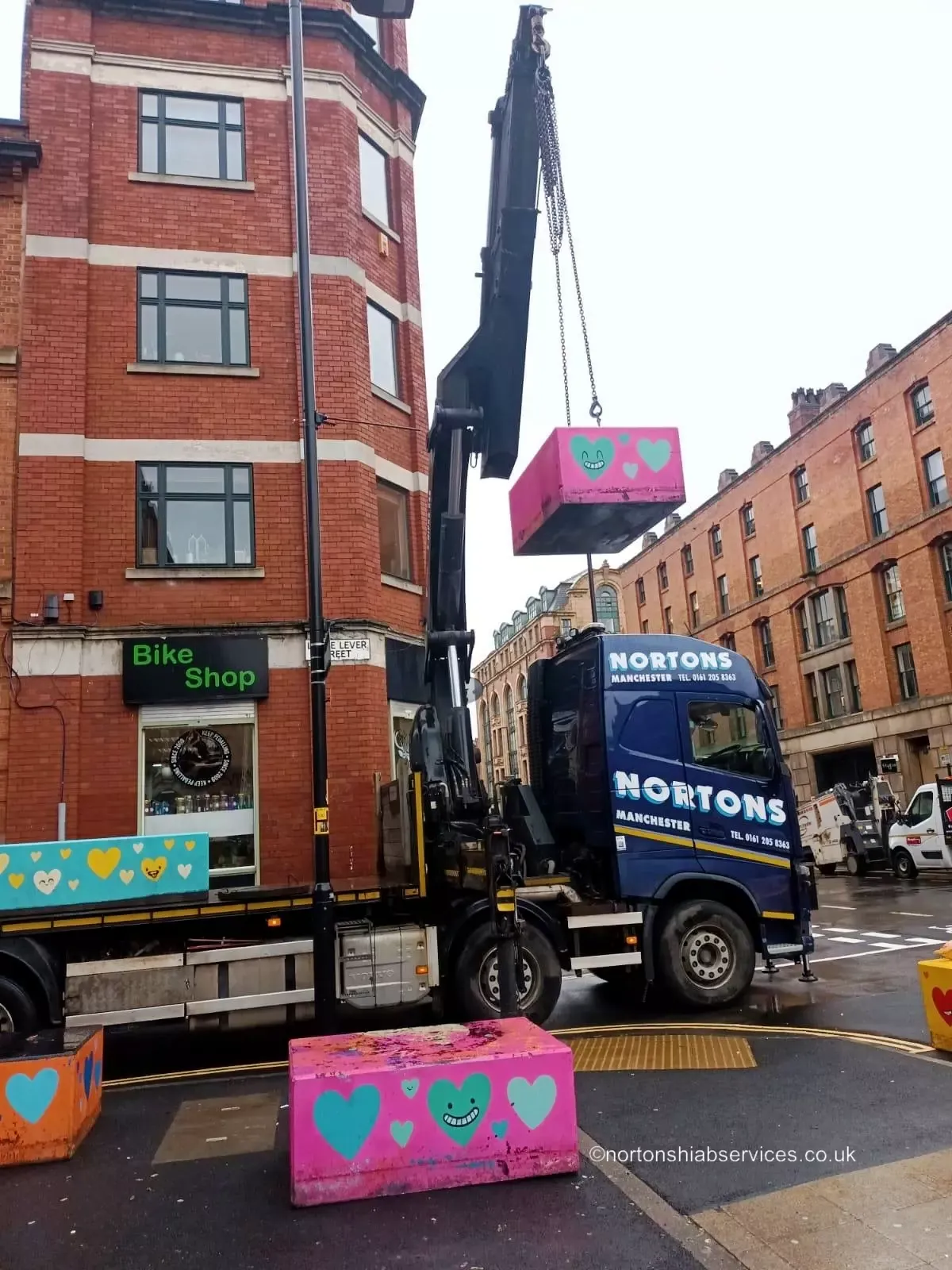 Nortons wagon and drag hiab lifting a load in a city centre street