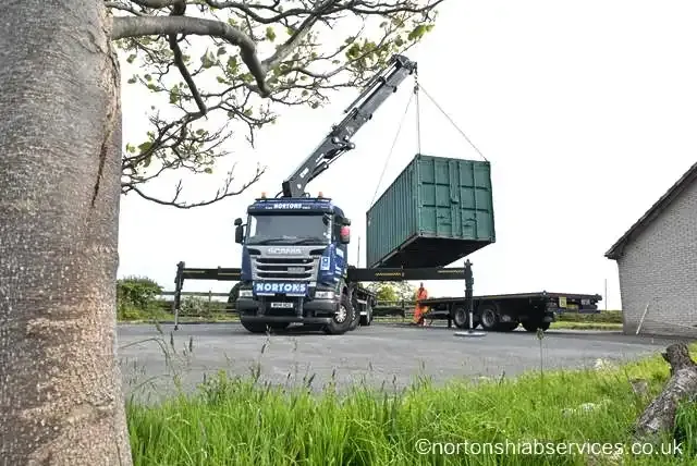 Nortons wagon and drag hiab lifting a container from the trailer