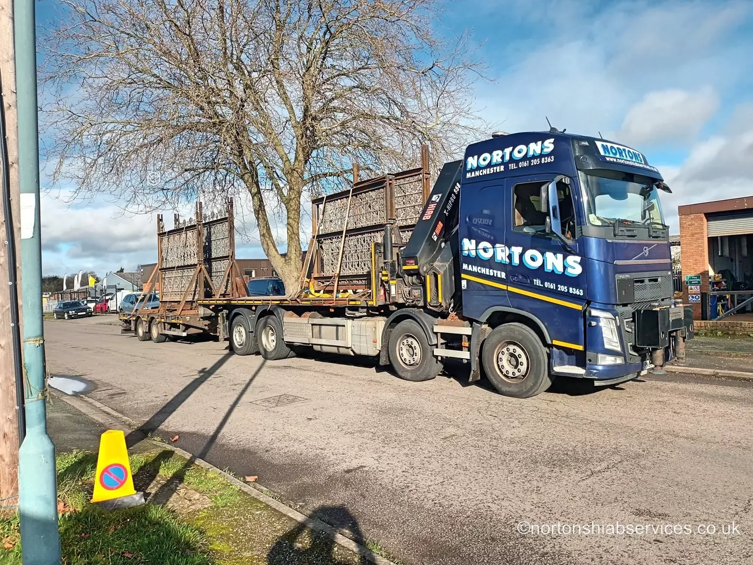 Nortons wagon and drag hiab loaded with long fencing panels