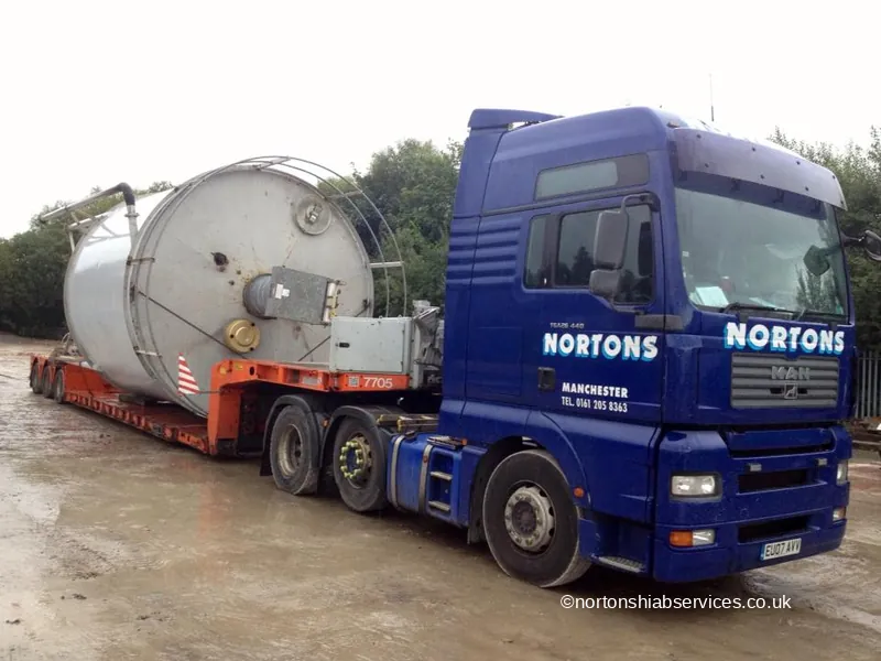 Oversized steel tank loaded across a Nortons trailer as a wide load