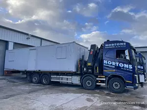 Refurbished portable cabins sold by our Cabins division loaded and ready for delivery by our Hiab Transport